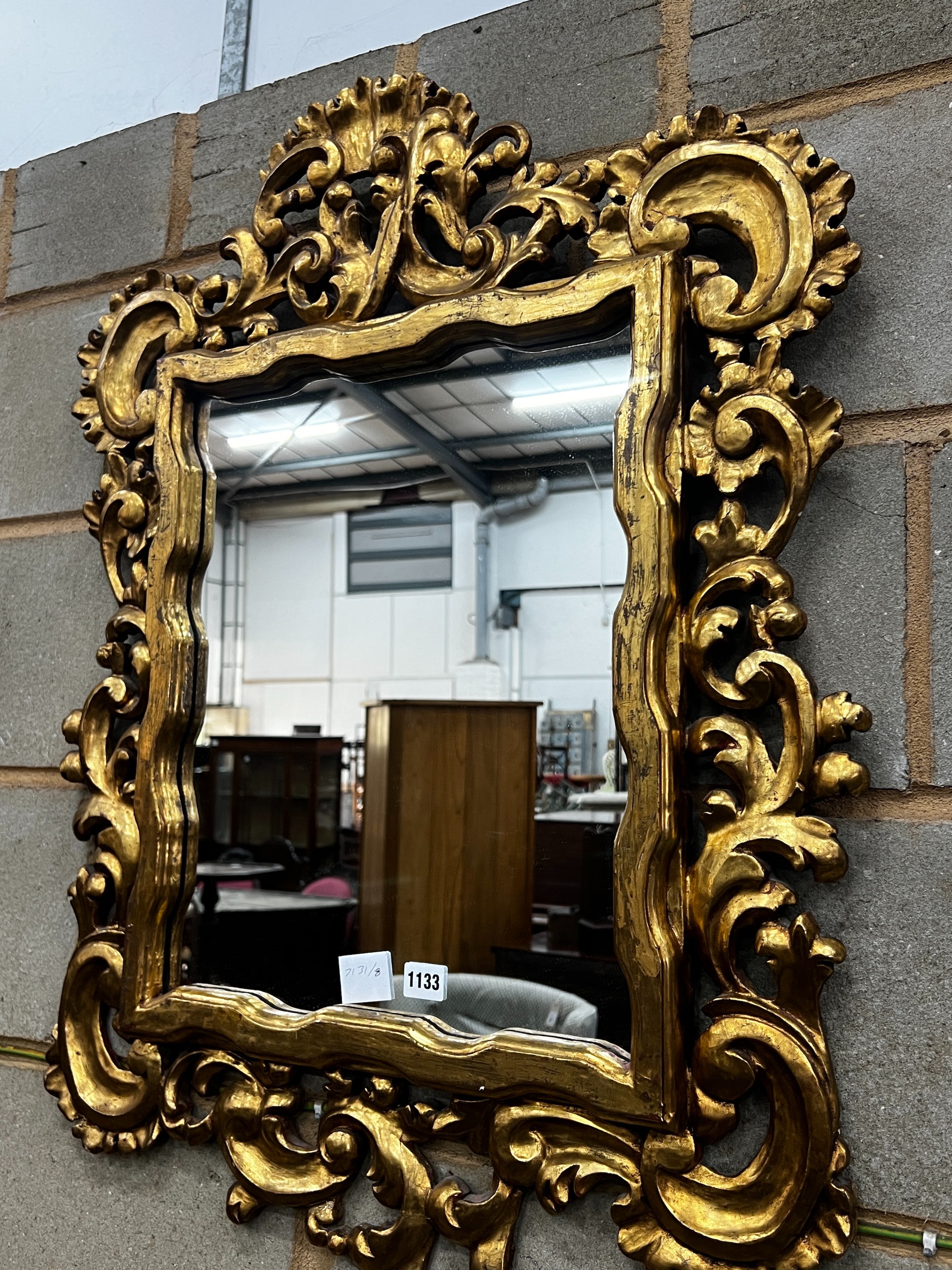 A rectangular Florentine style scrolling carved gilt framed wall mirror, width 63cm, height 90cm
